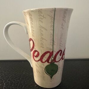 222 Fifth Ceramic Mug beige with script text large, red "Peace"
